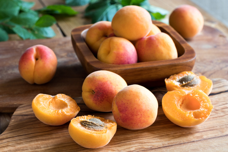Freshly harvested ripe apricots on a wooden tableの写真素材