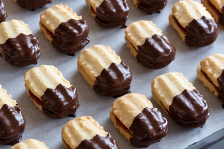 Christmas cookies filled with jam and dipped in chocolateの写真素材