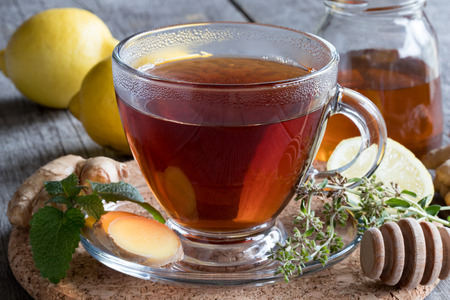 A cup of tea with ginger root, lemon and honeyの写真素材