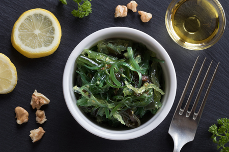 Salad made from fresh seaweed in a bowl on a table, top viewの写真素材