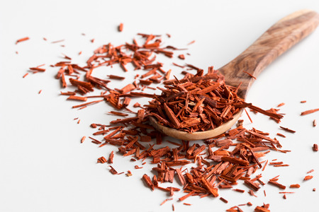 Pieces of sandalwood on a wooden spoon on a white background.の写真素材