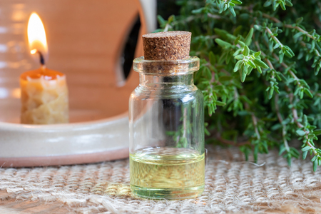 A bottle of essential oil with fresh thyme twigsの写真素材