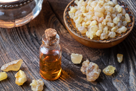 A bottle of essential oil with frankincense resin crystalsの写真素材