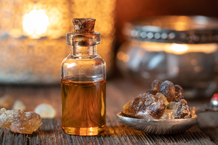 A bottle of essential oil with frankincense resin crystalsの写真素材