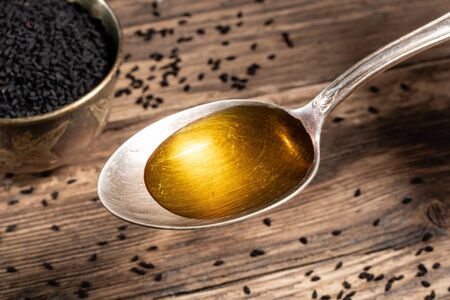 Black cumin seed oil on a spoonの写真素材