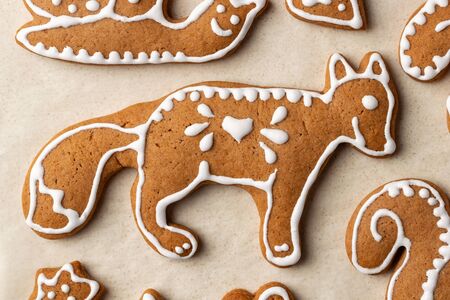 Homemade Christmas gingerbread cookies on parchment paper, top viewの写真素材