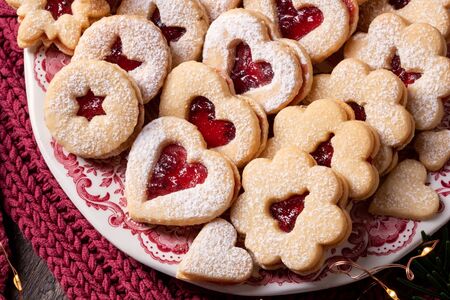 Linzer Christmas cookies on a vintage plate, top view