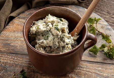 A jar of herbal butter made from young nettle leavesの写真素材