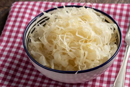 Fermented cabbage in a bowl on a tableの写真素材