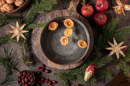 Candles made from nut shells floating in a bowl of water, top viewの写真素材