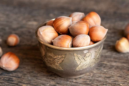 A bowl of hazelnuts on a table