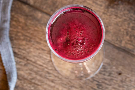 Red beet juice in a glass, top view