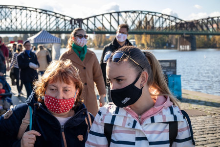 PRAGUE, CZECH REPUBLIC - OCTOBER 24, 2020: Women in face masks shopping at the Naplavka farmers market during the second wave of the coronavirus outbreakのeditorial素材