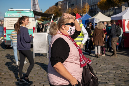 PRAGUE, CZECH REPUBLIC - OCTOBER 24, 2020: Woman in face mask at the Naplavka farmers market during the second wave of the coronavirus outbreakのeditorial素材