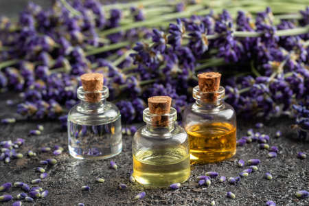 Essential oil bottles with fresh blooming lavender twigs