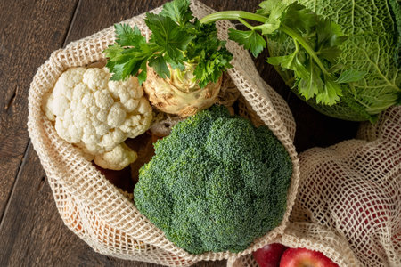 Broccoli, cauliflower, celery root and other fresh vegetables in ecological reusable mesh bags made of organic cotton - zero-waste conceptの写真素材
