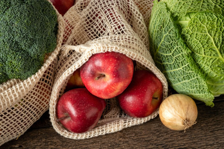 Apples and vegetables in ecological reusable mesh bags made of organic cotton - zero-waste conceptの写真素材