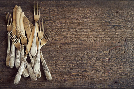 Old rusted vintage silverware on a wooden background, top view with copy spaceの写真素材