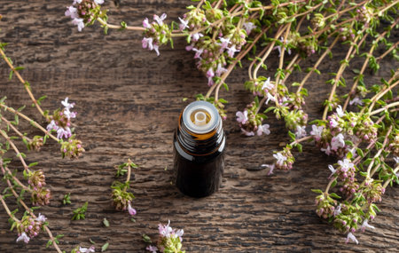 Essential oil bottle with blooming thyme plantの写真素材
