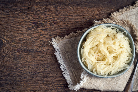 Fermented cabbage in a blue bowl, top view with copy spaceの写真素材