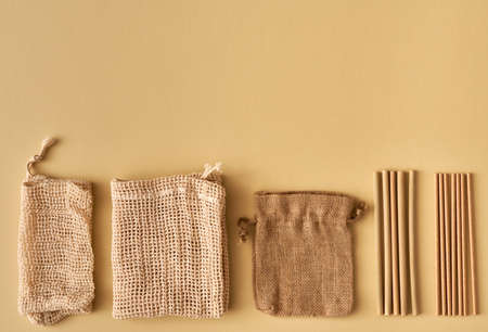 Mesh bags, a linen sac, bamboo and paper straws - ecological zero waste concept with copy spaceの写真素材