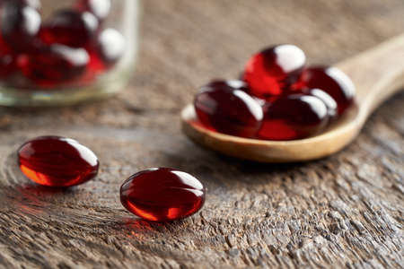 Krill oil capsules on a table, closeupの写真素材