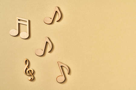 Wooden musical notes on a beige background with copy spaceの写真素材