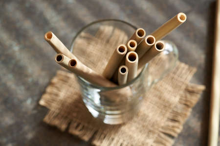 Bamboo straws on a table - zero-waste or sustainable lifestyle conceptの写真素材
