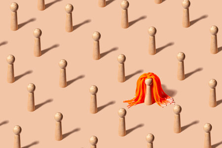 Creative pattern with equal figures representing people, one standing out with striking orange hair...