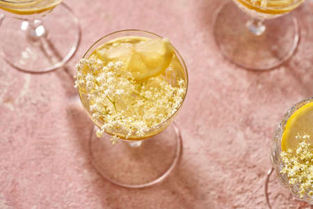 Homemade lemonade with fresh elder flowers on pink pastel backgroundの写真素材