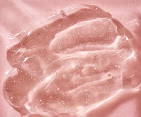 Transparaent aloe vera gel on pastel pink background. Natural healthy cosmetic product.