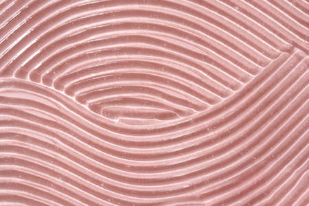 Aloe vera gel spread over pastel pink background with copy space. Natural healthy cosmetic product.
