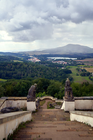 USTEK, CZECH REPUBLIC - AUGUST 29, 2021: Pilgrimage place on a hill called Kalvarie or calvary, with beautiful landscape in the backgroundのeditorial素材