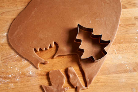 Preparation of gingerbread Christmas cookies - cutting out shapes from pastry dough