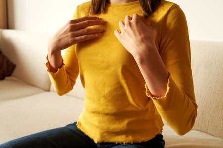Young girl practicing EFT or emotional freedom technique - tapping on the collarbone pointの写真素材