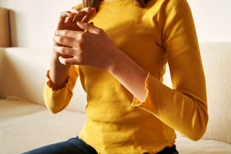 Teenage girl practicing EFT or emotional freedom technique - tapping on the karate chop pointの写真素材
