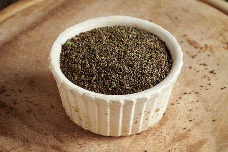 Ripe nettle seeds in a bowl - natural herbal nutritional supplementの写真素材