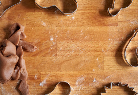 Christmas baking background with copy space, with gingerbread cookie dough and biscuit cuttersの写真素材