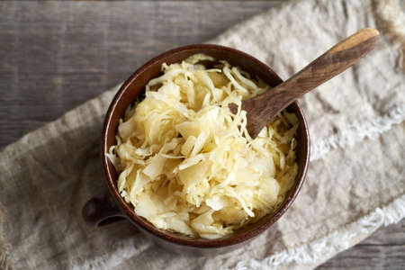 Homemade fermented cabbage or sauerkraut in a pot, top view
