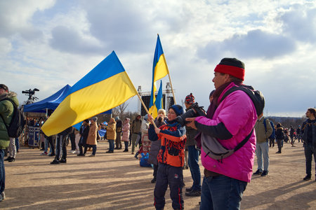 PRAGUE, CZECH REPUBLIC - APRIL 3, 2022: People holding Ukrainian flag at the Letna beneficial...