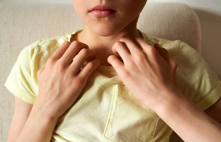 Child doing emotional freedom technique or EFT - tapping on the collarbone acupressure pointの写真素材