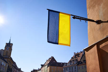 Ukrainian national flag hanging in a Czech town in support against Russian aggression on a sunny dayの写真素材