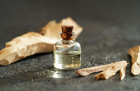 A bottle of aromatherapy essential oil with white sandalwoodの写真素材