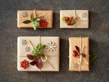 Christmas present boxes wrapped in ecological recycled paper with fresh wintergreen and wooden...