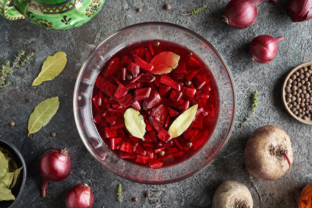 Fermented red beet kvass in a bowl on a dark table, top viewの写真素材