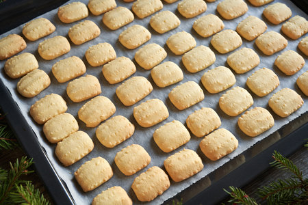 Traditional Christmas cookies on a baking sheet on a table