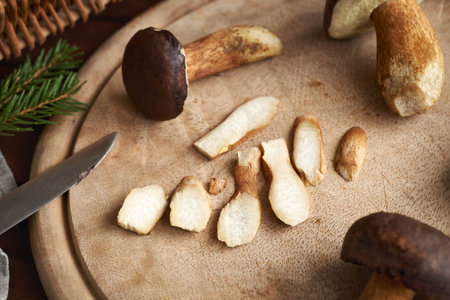 Cutting up fresh wild edible mushrooms on a tableの写真素材