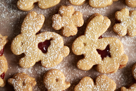 Linzer cookies in the shape of Easter bunnies filled with strawberry marmalade and dusted with...