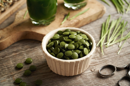 Green barley grass tablets with freshly grown blades and homemade juice