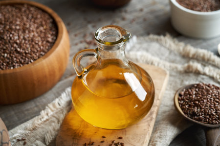 Flax seed oil in a glass bottle on a tableの写真素材